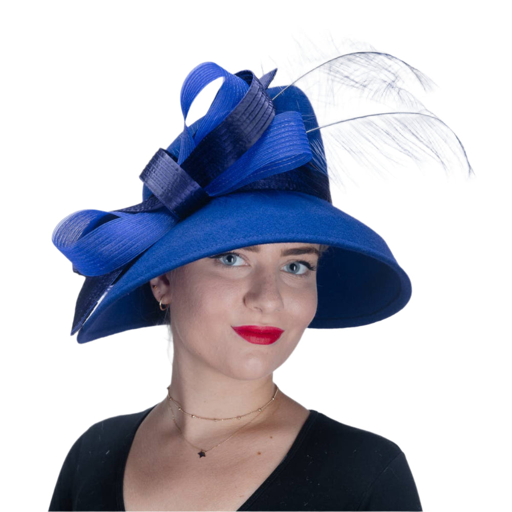 Woman wearing a large blue hat with a bow on a white background