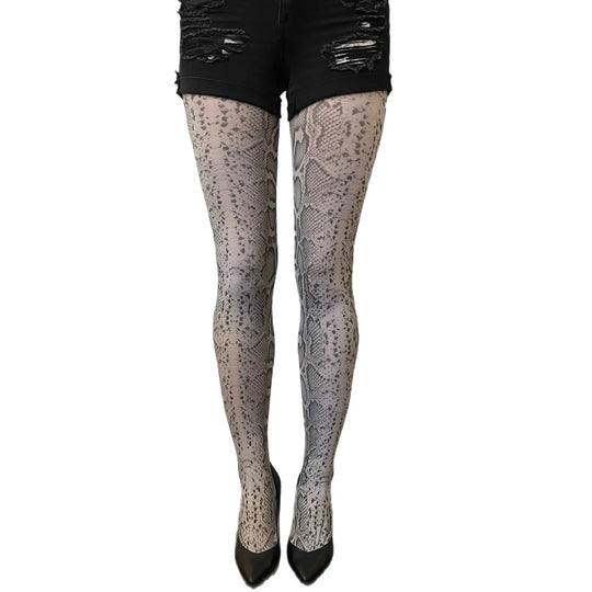 Patterned tights worn with black shorts on a white background