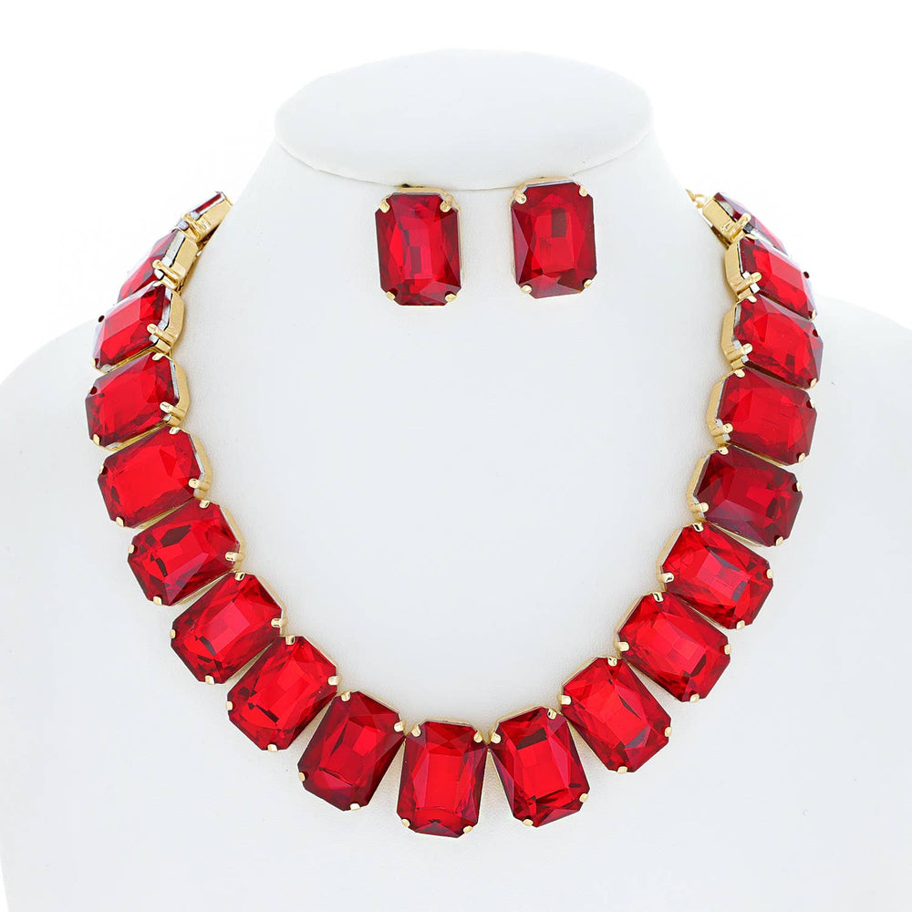 A red octagon cut collar necklace set with matching earrings on a mannequin.