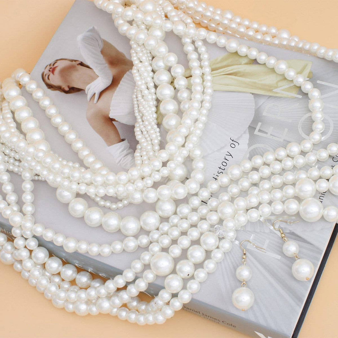 Multiple strands of pearls on a magazine with a blurred background