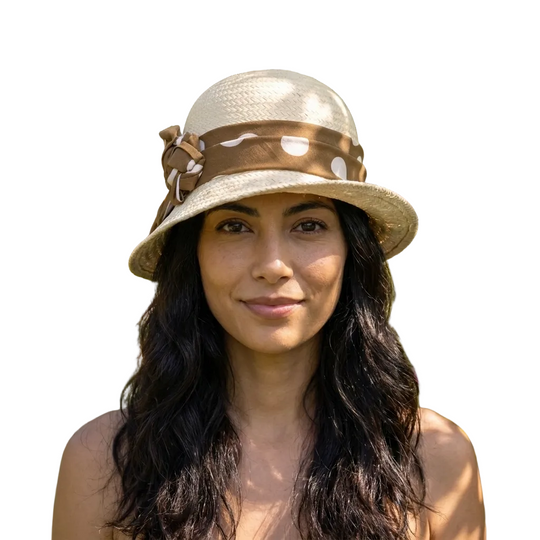 Woman wearing a straw hat with a brown band in a garden setting