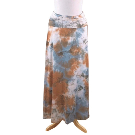 A tie-dye maxi skirt with a square shape, featuring a mix of blue and orange colors. The skirt is displayed on a mannequin against a neutral background.