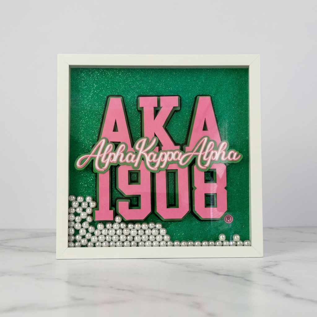 Framed decorative sign with 'AKA Alpha Kappa Alpha 1908' text on a green background
