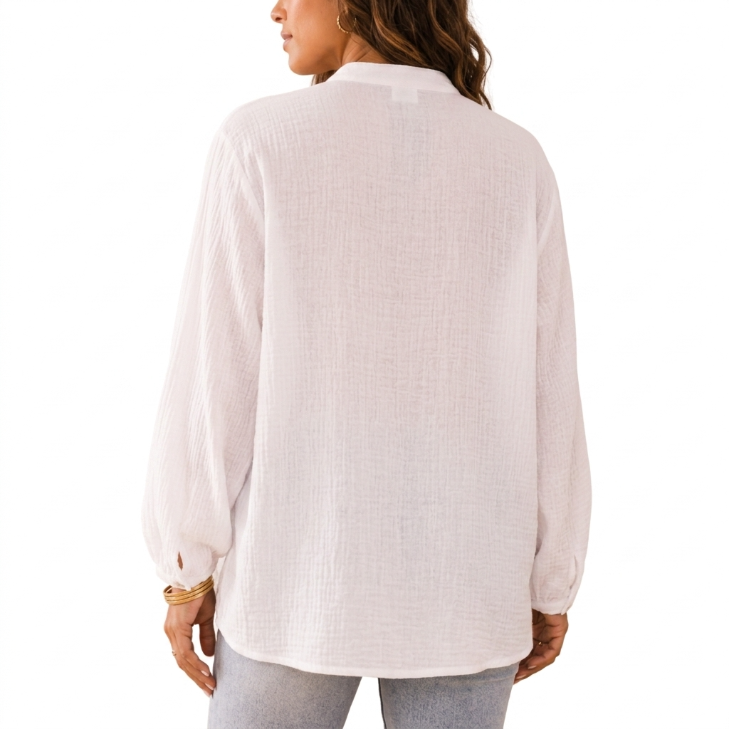 Person wearing a light-colored blouse on a white background