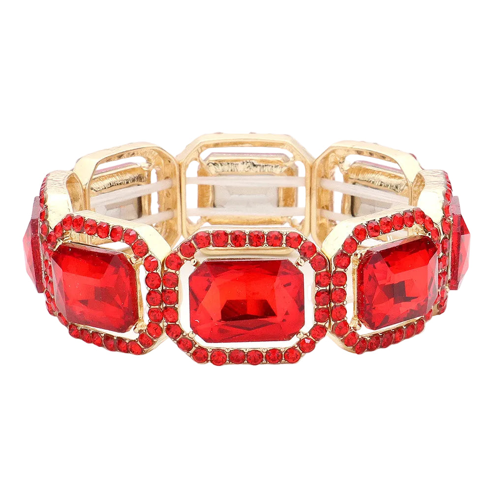 A gold-plated stretch bracelet featuring three large rectangular red gemstones, each surrounded by a border of small round red crystals, set against a light gray background.
