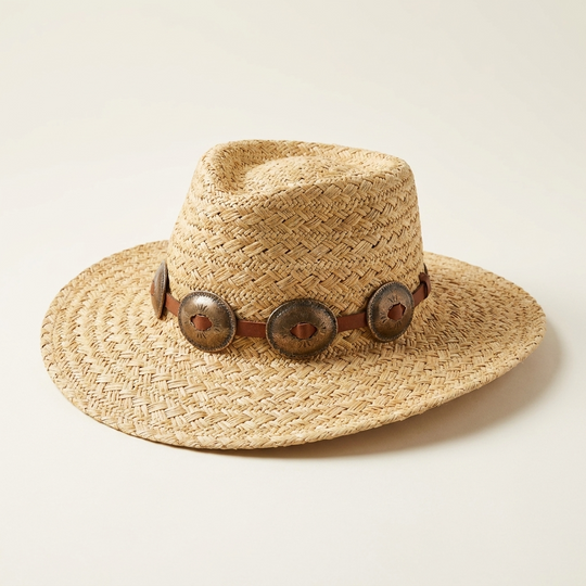 Straw hat with decorative band on a light beige background