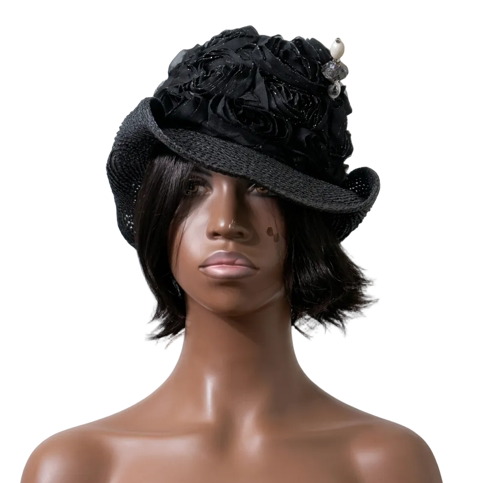 Mannequin head wearing a black floral hat against a plain background