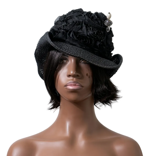 Mannequin head wearing a black floral hat against a plain background