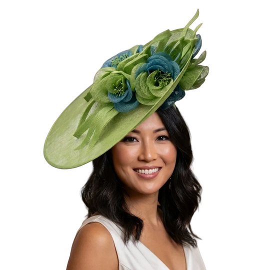 Woman wearing a green floral hat in an elegant indoor setting