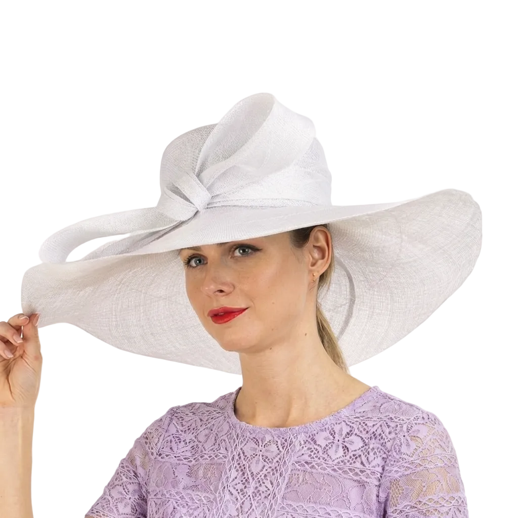 Woman wearing a large white hat with a bow on a white background