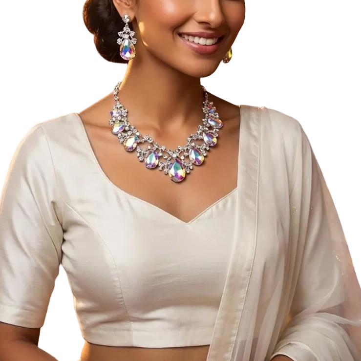 Woman in a white saree with jewelry in an ornate setting