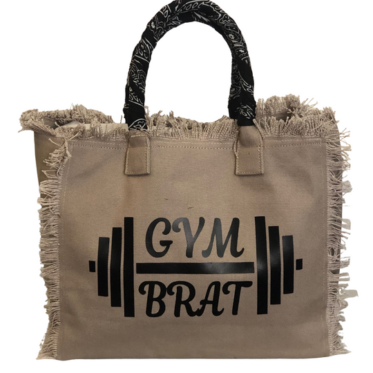 Gym Brat Shoulder Tote - Bandana - Beige
We have improved this best-selling bag! Now larger and roomier it's a shoulder tote and fully lined too! Fringe Bag Perfect everyday bag! - "Gym Brat" Fully lined canvas tote with soft-support bottom and bandana covered handles. Inside bag has 1 convenient inside zippered pockets and 2 insert pockets. Bag handles are at 7.5" drop and fits comfortably around the shoulder. Dimensions: 12"X14"X6.5" Made in USA
Gym Brat Shoulder Tote - Bandana - Beige
Gym Brat, fully lin