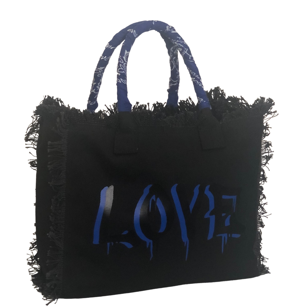 Dripping LOVE Shoulder Tote - Blue
We have improved this best-selling bag! Now larger and roomier it's a shoulder tote and fully lined too! Fringe Bag Perfect everyday bag! - We say around here that you are just, "dripping LOVE" Fully lined canvas tote with soft-support bottom and bandana covered handles. Inside bag has 1 convenient inside zippered pockets and 2 insert pockets. Bag handles are at 7.5" drop and fits comfortably around the shoulder. Dimensions: 12"X14"X6.5" Made in USA Tee shirt available und