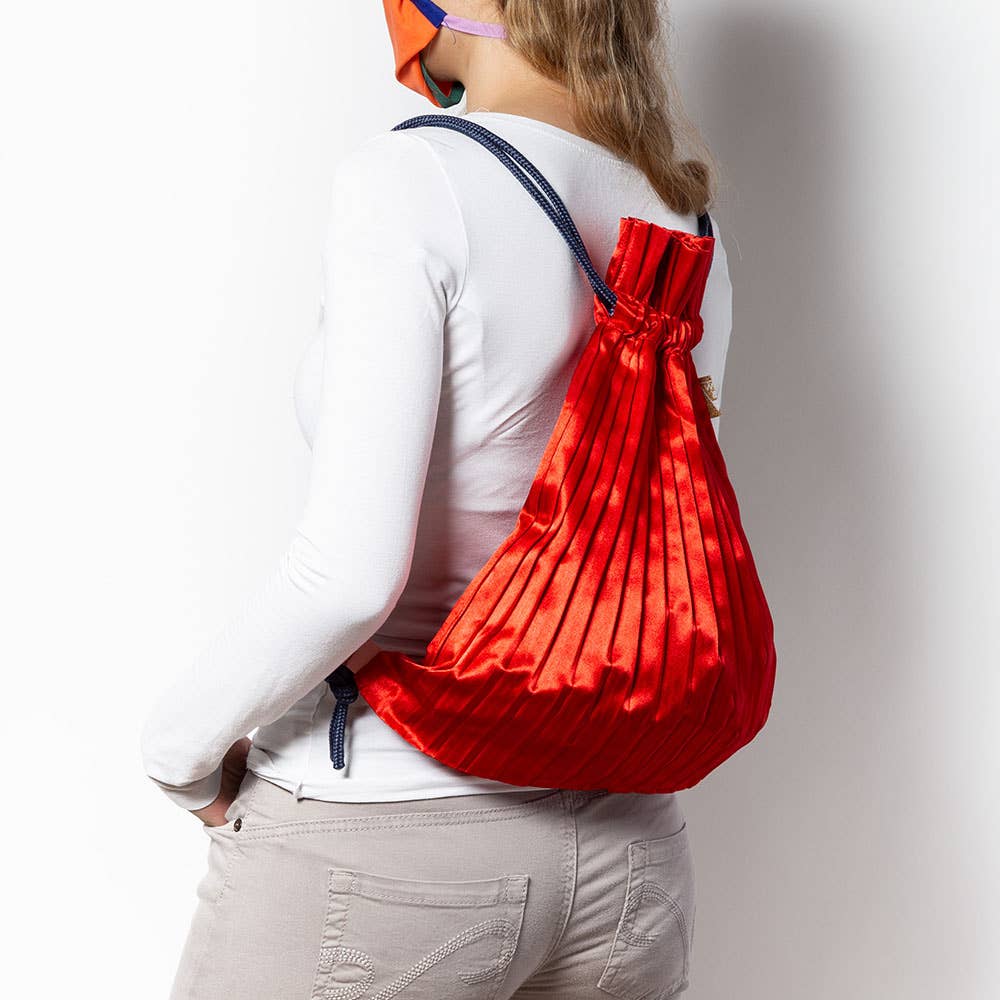 Write Sketch & - RED SATIN PLEATED BACKPACK
Red color satin pleated backpack, fully open and extended size 44 x 45 cm. The backpack is made of permanently pleated silk-effect synthetic satin, with black loops and adjustable cords in high quality blue braid in contrast with the satin of the bag. The backpacks are designed to be used every day, they are very capacious and resistant as well as elegant and well finished. The opening is very simple and the closure is done by pulling the cords of the shoulder str
