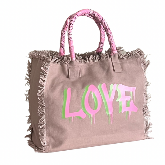 Dripping LOVE Shoulder Tote - Pink/Green
We have improved this best-selling bag! Now larger and roomier it's a shoulder tote and fully lined too! Fringe Bag Perfect everyday bag! - We say around here that you are just, "dripping LOVE" Fully lined canvas tote with soft-support bottom and bandana covered handles. Inside bag has 1 convenient inside zippered pockets and 2 insert pockets. Bag handles are at 7.5" drop and fits comfortably around the shoulder. Dimensions: 12"X14"X6.5" Made in USA Tee shirt availab