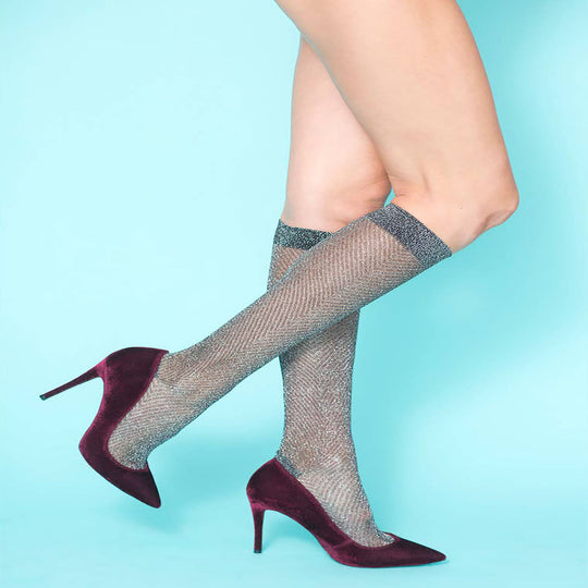 Gun Metal Knee High Metallic Sock
Featuring a timeless herringbone design in a sophisticated gunmetal metallic design with a wide elastic band. Can be styled a variety of ways- slouchy around the calf or pulled up at the knee. These socks are an instant fashion game-changer and can be effortlessly paired with booties, boots, heels or flats. Wear them with skirts, dresses or peeking out under jeans or pants.
Gun Metal Knee High Metallic Sock
Featuring a timeless herringbone design in a sophisticated gunmetal