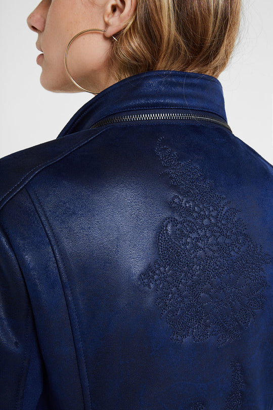 Slim Biker Jacket w/ Embroidery - Jean
Slim Biker Jacket w/ Embroidery - Jean Applied harmoniously, the embroideries of paisley tears provide a touch of subtle elegance to the back, the waist and the V-neck with lapels of this slim biker type jacket with crossed zip fastener. Its leather effect fabric shows a worn effect which is pure attitude. V-neck crossed with lapels Zip fastener Two pockets with zipper Multicolour floral print on inner lining Embroidery of matching mandalas High collar removable with z