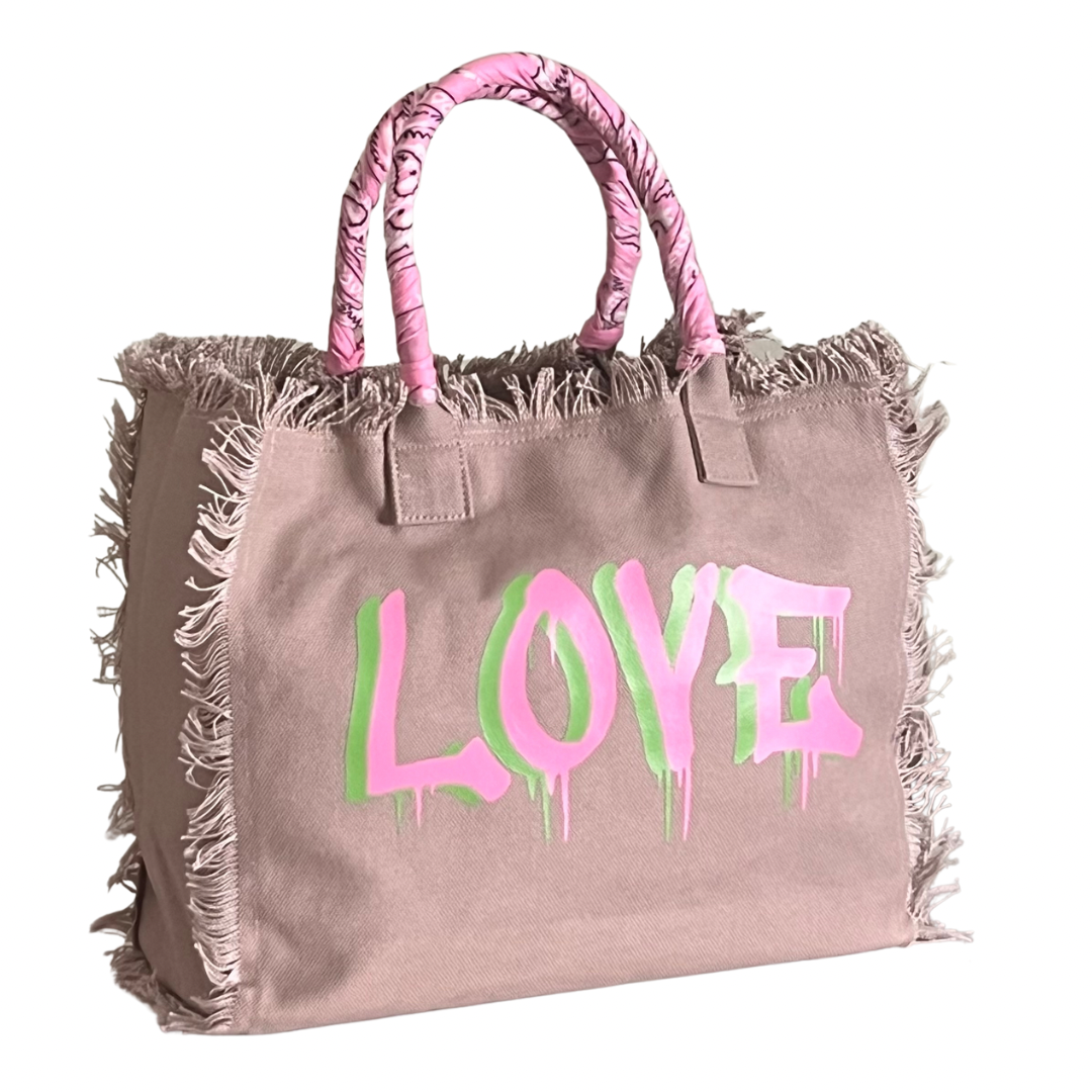 Dripping LOVE Shoulder Tote - Pink/Green
We have improved this best-selling bag! Now larger and roomier it's a shoulder tote and fully lined too! Fringe Bag Perfect everyday bag! - We say around here that you are just, "dripping LOVE" Fully lined canvas tote with soft-support bottom and bandana covered handles. Inside bag has 1 convenient inside zippered pockets and 2 insert pockets. Bag handles are at 7.5" drop and fits comfortably around the shoulder. Dimensions: 12"X14"X6.5" Made in USA Tee shirt availab