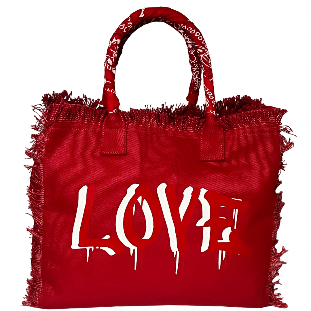 Dripping LOVE Shoulder Tote - Red/White
We have improved this best-selling bag! Now larger and roomier it's a shoulder tote and fully lined too! Fringe Bag Perfect everyday bag! - We say around here that you are just, "dripping LOVE" Fully lined canvas tote with soft-support bottom and bandana covered handles. Inside bag has 1 convenient inside zippered pockets and 2 insert pockets. Bag handles are at 7.5" drop and fits comfortably around the shoulder. Dimensions: 12"X14"X6.5" Made in USA Tee shirt availabl