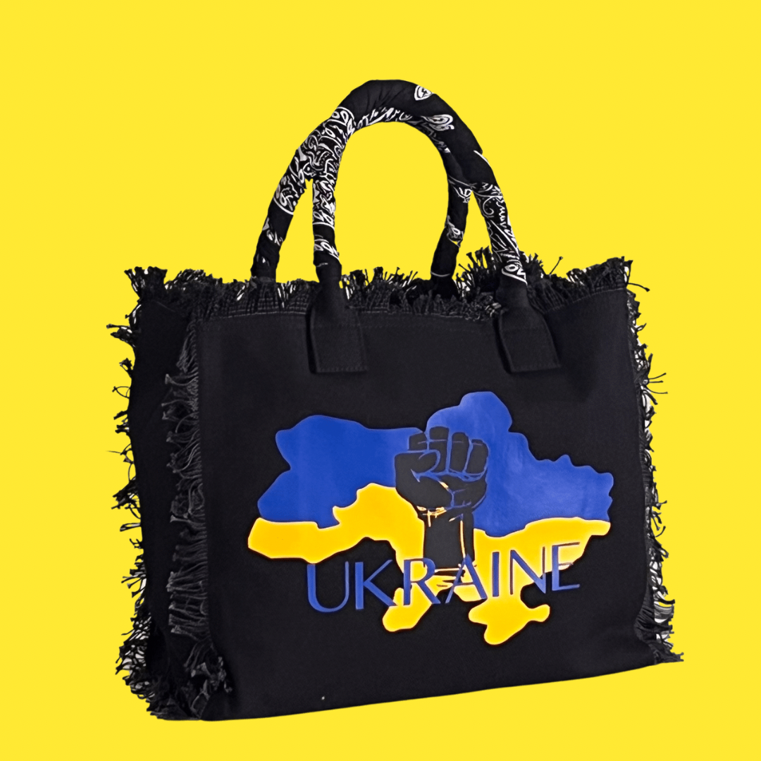 FUNDRAISER - Ukraine Shoulder Tote - Black
UKRAINE FUNDRAISER TOTE This expressive tote was designed as part of the Sandi_J Strength & Unity Tote Collection. The unique design signifies standing in solidarity with our Ukrainian sisters and brothers. 50% of proceeds will be donated to SIFH Global (501c3) for the purchase and delivery of diesel generators to Ukraine Fully lined canvas tote with soft-support bottom and bandana covered handles. Inside bag has 1 convenient inside zippered pockets and 2 insert po