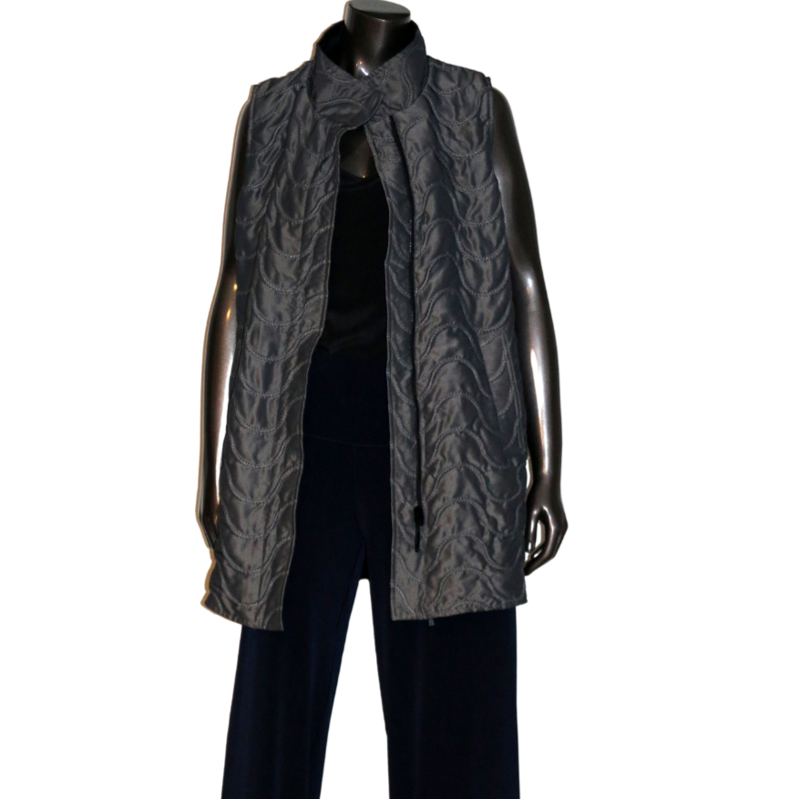 Elongated Vest Mycra Pac Vest - Gunmetal
Mycra Pac Vest Actual Mycra Pac vest color is dark metallic silver (Nickel/Black) shown in 2nd photo. Reversible quilted zip-up vest features a semi-fitted silhouette, elongated length, pockets, and standing collar. Reverses to black with adjustable cinch waist. Sold with matching drawstring carrying bag. Features: Mycra Pac Vest 55% nylon, 35% polyester dry clean made in USA medium measures 44" bust, 32" length style # 13146 Mycra Pac products run large. We recommen