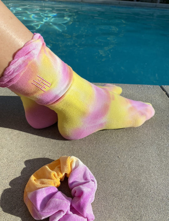 Tie Dye Sock & Scrunchie Set - Pink Yellow
Tie Dye Ruffle Sock with Matching Tie Dye Scrunchie Set The tie dye phenomenon lives on! These socks are crafted to perfection in this tie dye soft stretch cotton socks with a ruffle trim. and Each pair comes with matching large tie dye velvet scrunchie and personalized packaging. Hand-dyed design. Each pair is unique due to the dyeing process and come in a longer length for multiple styling options. Wear them with your favorite sneakers, sandals and heels. With or