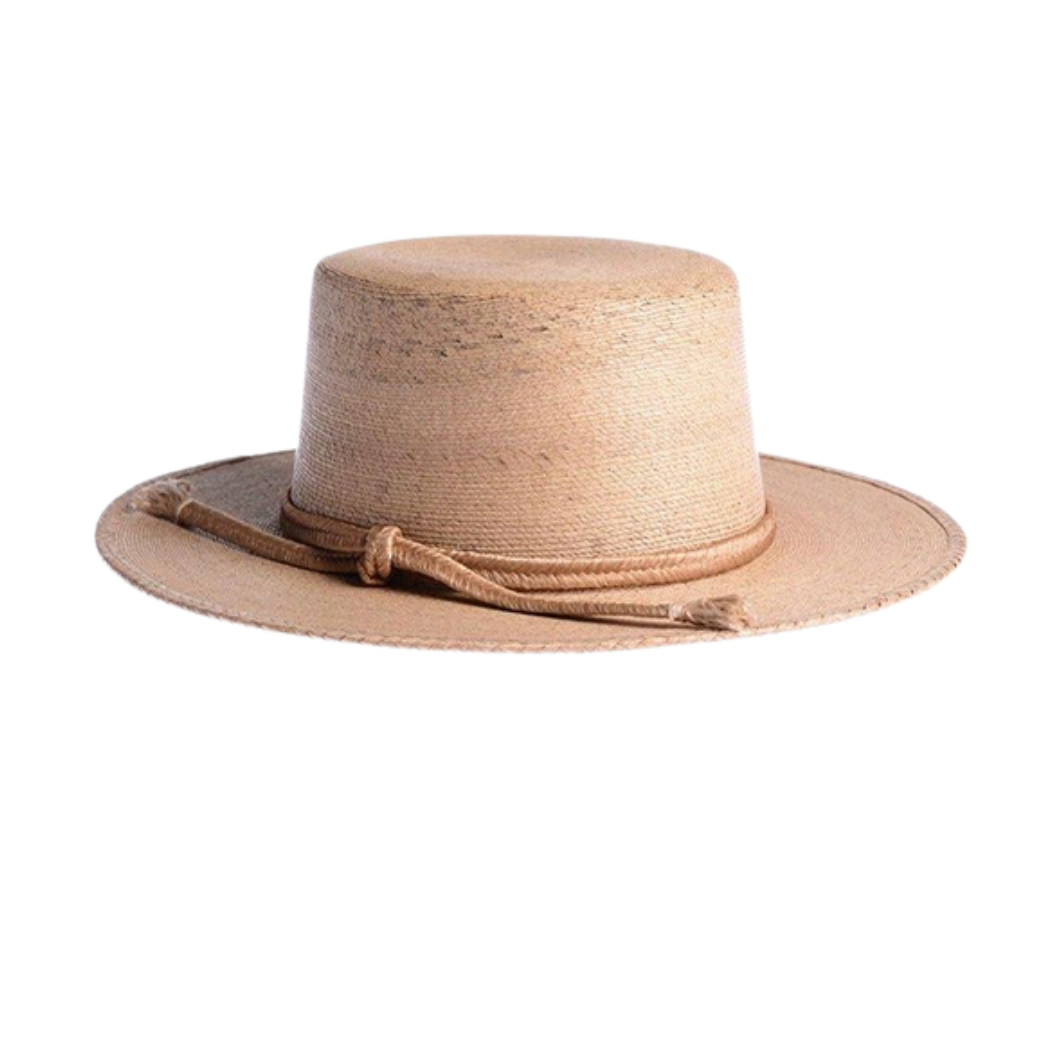 Carmen Cordobes Palm Leaf Natural Hat
The design of the Carmen hat was inspired by the beach and the palm trees of the Mexican coast. As such, artisan hands braid and interlace palm leaves to create the finished design. It’s completed with a rustic cotton-tied trim, making for an updated take on a classic boater hat. 100% Palm leaf, natural color Medium 58 cm Crown 4” Brim 3” Cordobes crown 100% cotton tied trim Inner elastic Spot/special cleaning
Carmen Cordobes Palm Leaf Natural Hat
The Carmen hat was ins