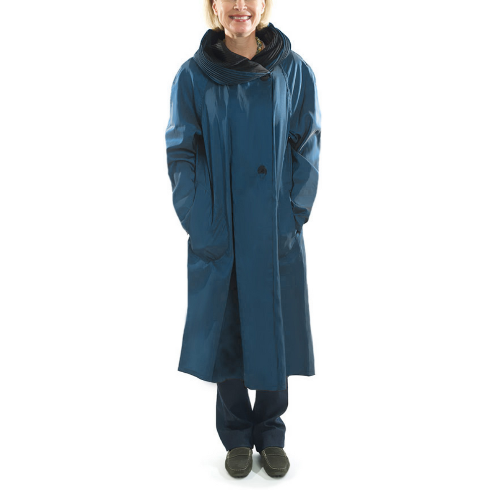 Tea Length Donatella Rain Coat - Sapphire
A reversible, water-resistant and lightweight rain jacket falls to the knee in an A-line silhouette. Features include extra long raglan sleeves, deep pockets, and a unique accordion pleat hood which doubles as an elegant shawl collar. 