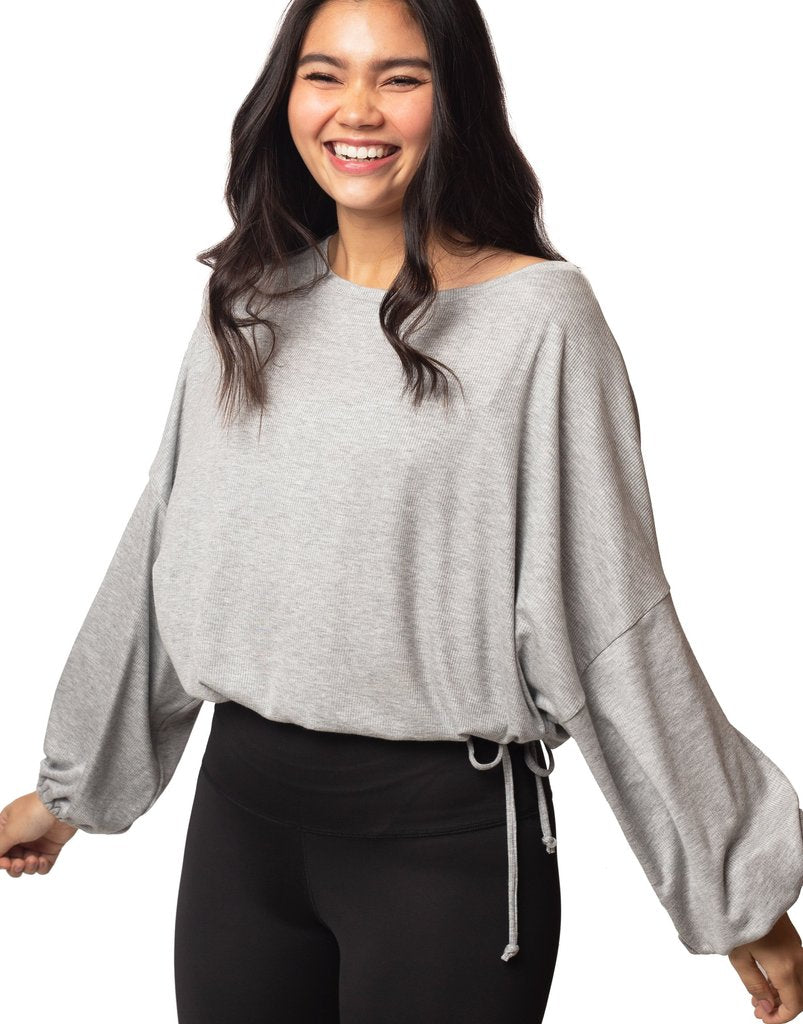 Cassidy Ribbed Knit Top - Heather
The new slouchy, oversized CASSIDY top features a beautiful boat neck, flowing gathered bell sleeves, and a drawstring tie waist. The luxuriously soft, stretchy black ribbed knit drapes gorgeously over the body. The perfect piece to pair with our leggings for an on-trend studio to street look. FABRIC 92% rayon/8% spandex4-way stretch SIZING XS/S and M/L (Model is 5'5" wearing size XS/S) CARE Wash inside out in cold water; no bleach; hang or lay flat to dry. Do not iron. Han