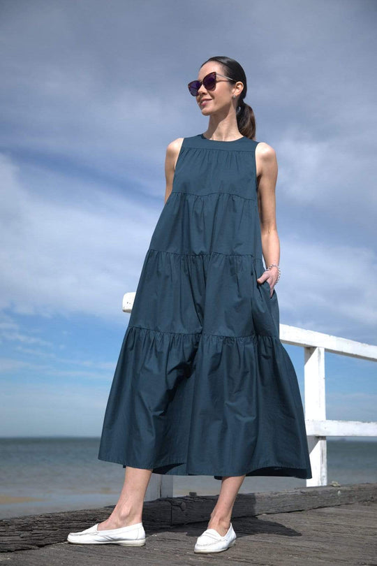 Florence Tiered Dress - Teal
Our best selling Florence is back in Teal The Florence is sleeveless tiered maxi dress cut from cotton-poplin that's crisp and breathable and falls in a﻿ trapeze s silhouette to the ankle. The Florence is the easiest one-and-done outfit of the season and creates a carefree mood. In direct sunlight the dress has more of a blue tinge. Designed for an oversized fit Back button fastening Round Neck Side pockets Tiered structure Cotton- poplin Ankle Length Machine wash cold delicate,